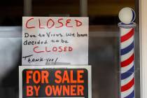 In this April 2, 2020 file photo, "For Sale By Owner" and "Closed Due to Virus" signs are displ ...