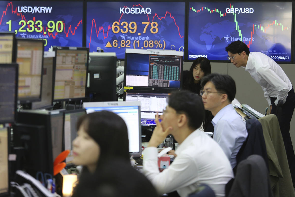 Currency traders watch monitors at the foreign exchange dealing room of the KEB Hana Bank headq ...