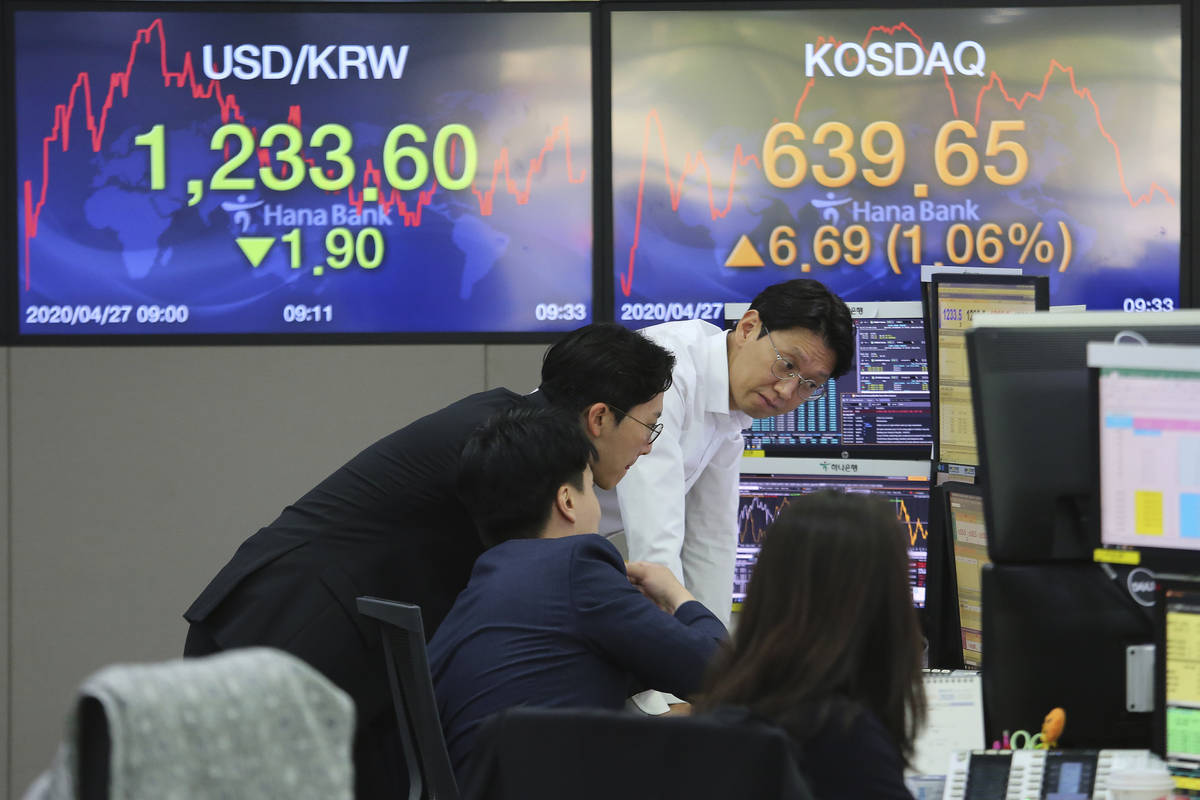 Currency traders watch monitors at the foreign exchange dealing room of the KEB Hana Bank headq ...