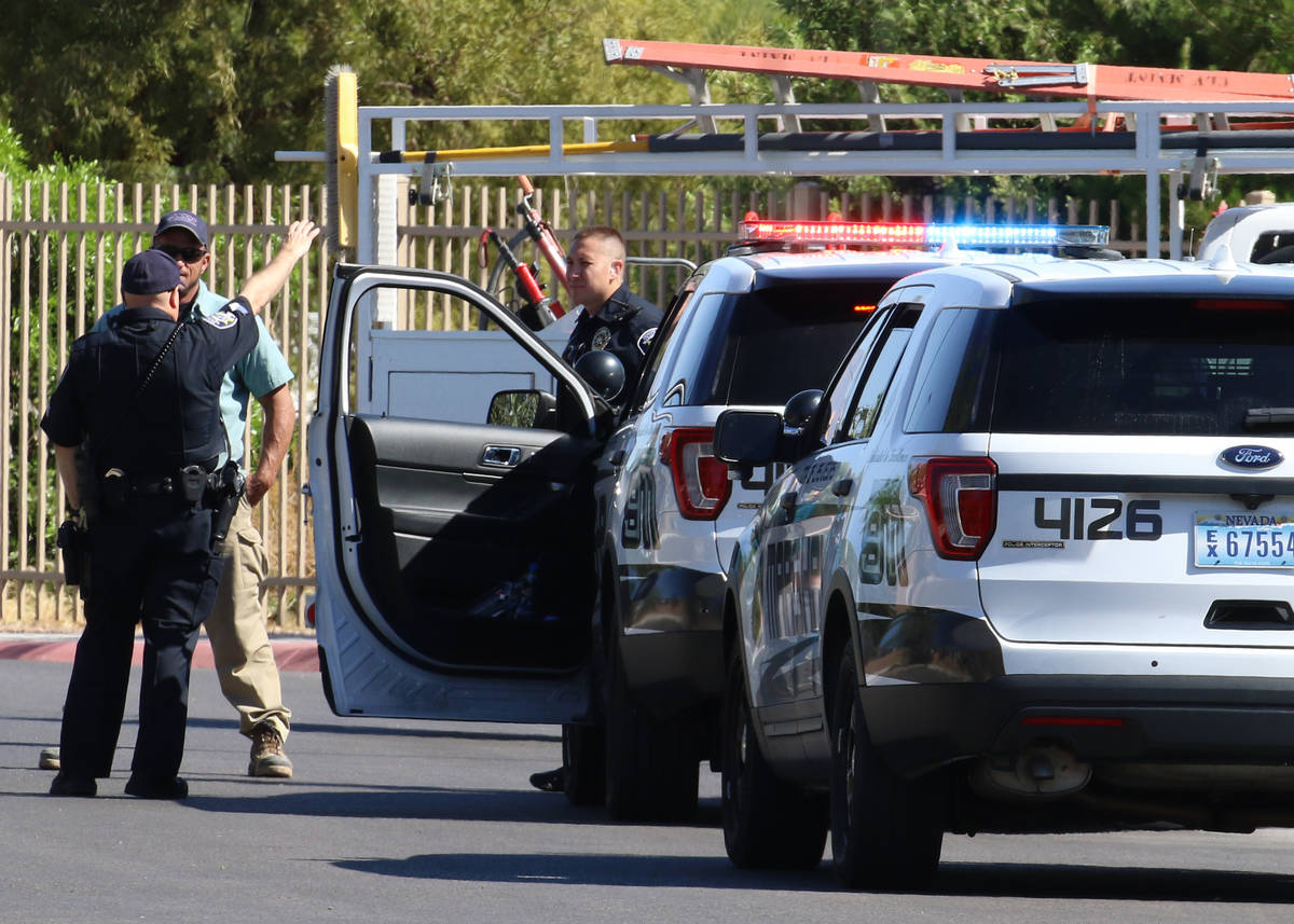Members of the marshal's office are seen as Las Vegas police investigate after a man's body was ...