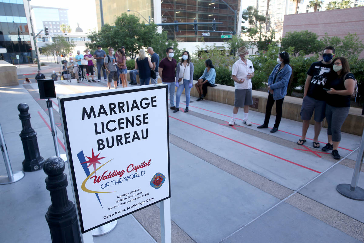 Couples, including first-in-line Jenny Paez and George Wells of Las Vegas, right, wait for for ...