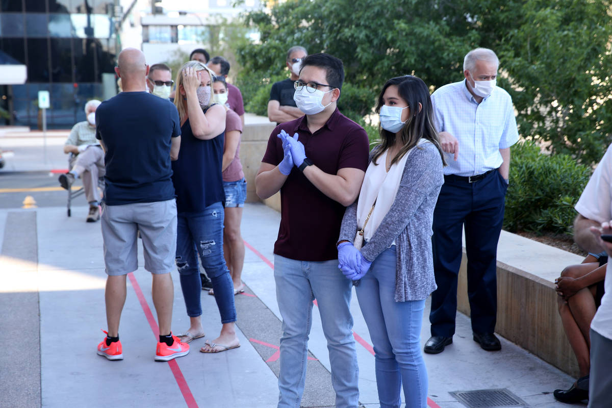 Couples, including Kevin Dedace and Lori Beltran of Los Angeles, center, wait for for the Clark ...