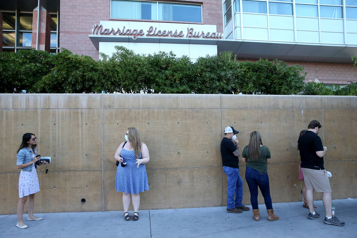 Celyna Lucer, left, and Amy Winters, both of Las Vegas, wait for the Clark County Marriage Lice ...