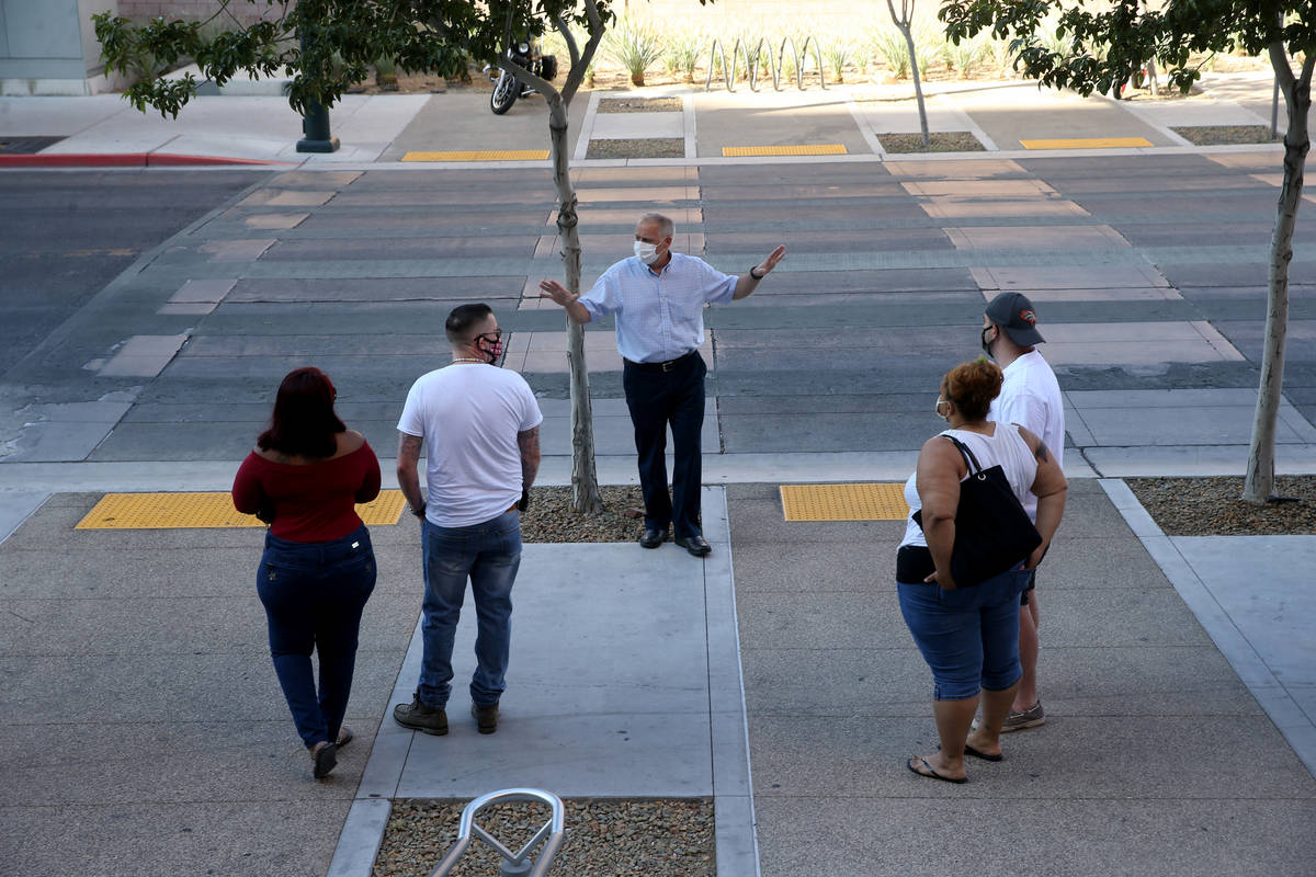 Carl Bates, assistant county clerk, gives instructions to couples in line at the Clark County M ...