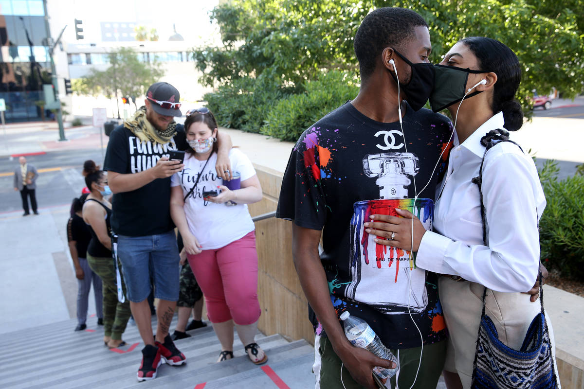 Couples including Mouhamadou Ba and Turquoise Martin-Ba of Los Angeles, right, wait in line at ...