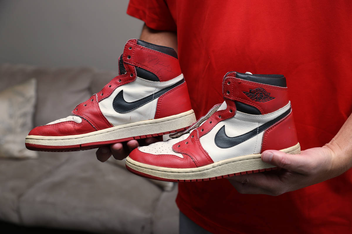 Trent Othick shows a pair of Air Jordan 1 shoes signed by Michael Jordan inside his Las Vegas h ...