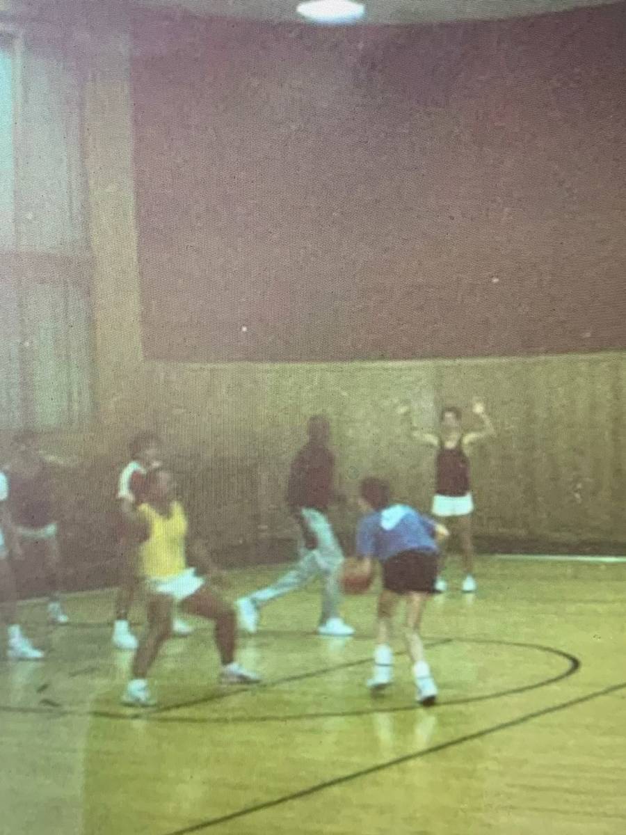 Michael Jordan, middle (black shirt, silver pants) is shown in a Polaroid snapshot playing pick ...