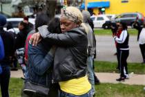 Bystanders comfort each other at the scene of a shooting where five people were killed in Milwa ...