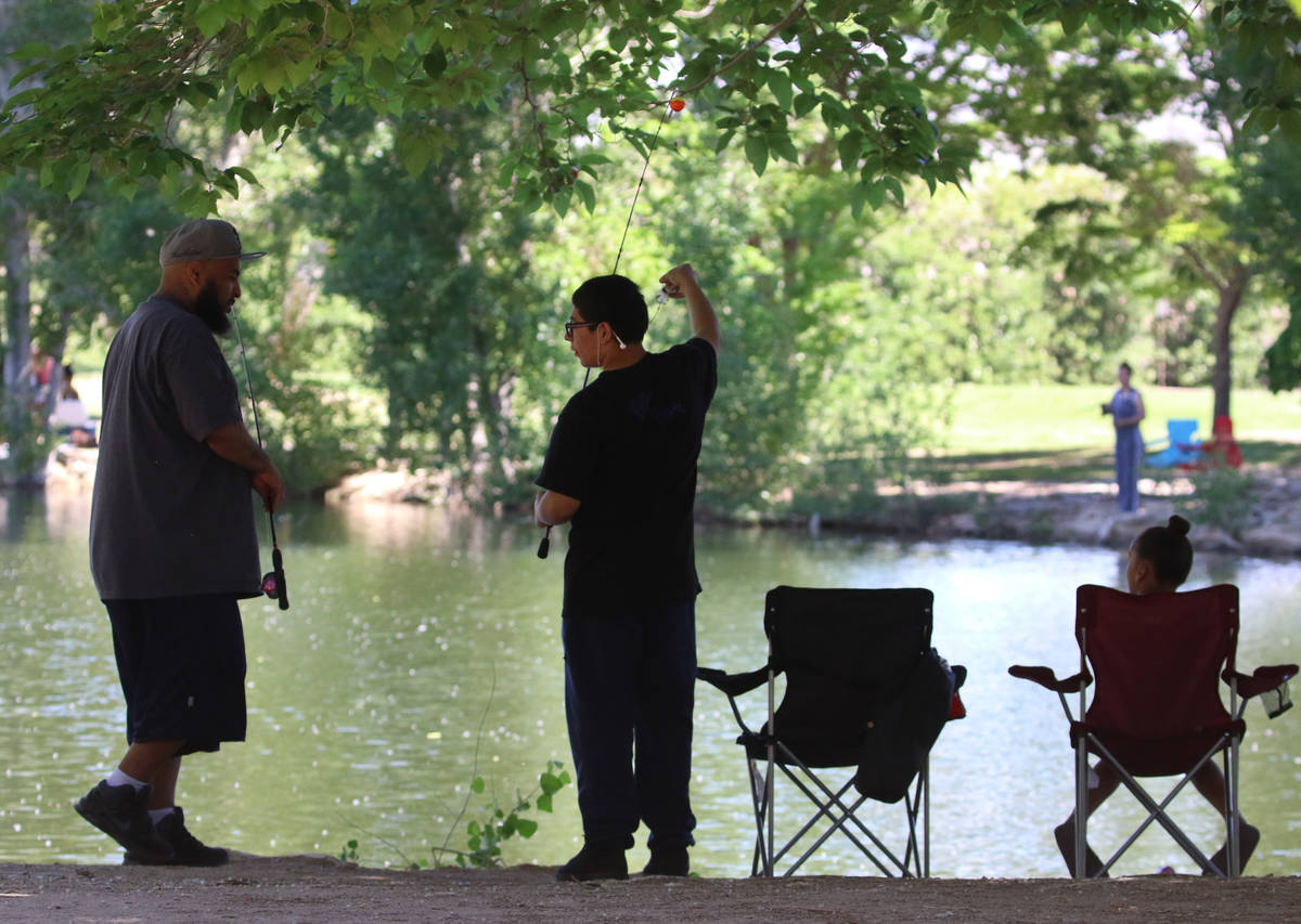 Devon Caldwell, left, and his son Alfonso, 12, and daughter, Daelynn, 8, fish at Floyd Lamb Par ...