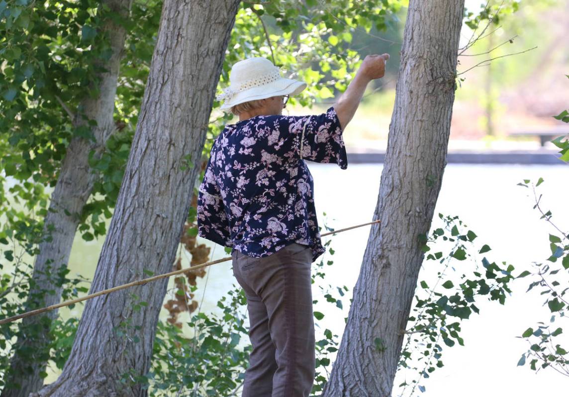 Tatiana Barbaros, 69, prepares her fishing rod at Floyd Lamb Park Tuesday, April 28, 2020, in L ...