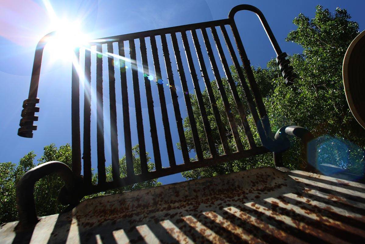 Park charcoal grill is seen against the blue sky and a shining sun at Floyd Lamb Park Tuesday, ...