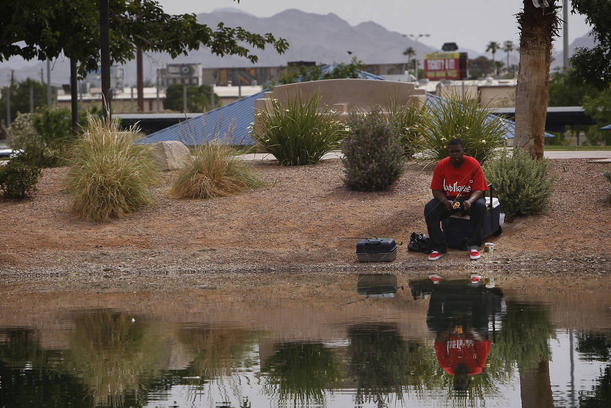 Antonio Asberry fishes in the freshly stocked pond at Lorenzi Park in Las Vegas on Friday, May ...