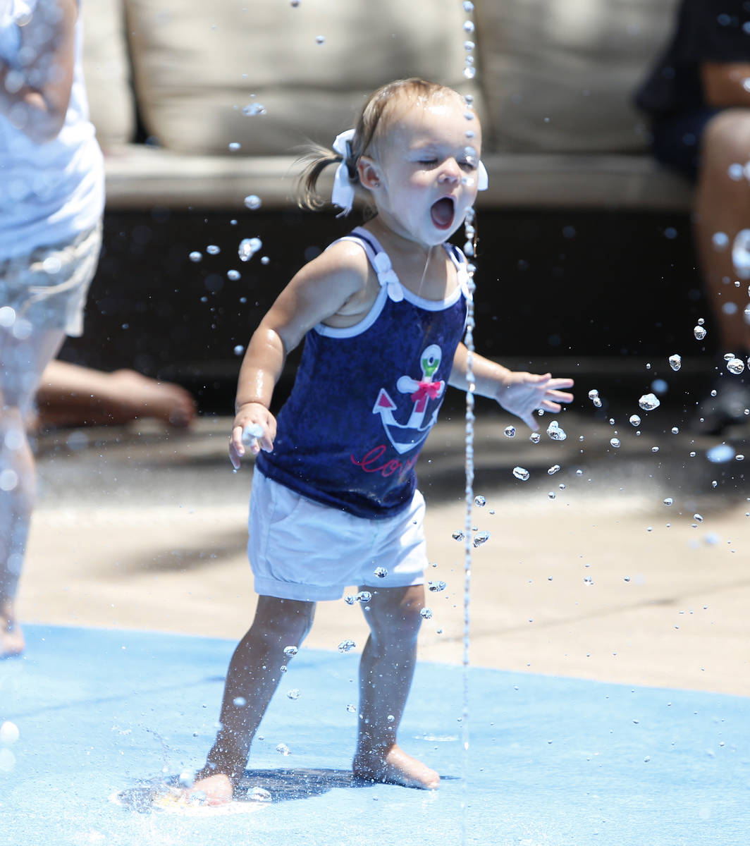 Layke Sandoval, 2, plays during a hot day at a splash pad on Saturday, May 30, 2015, at The Dis ...
