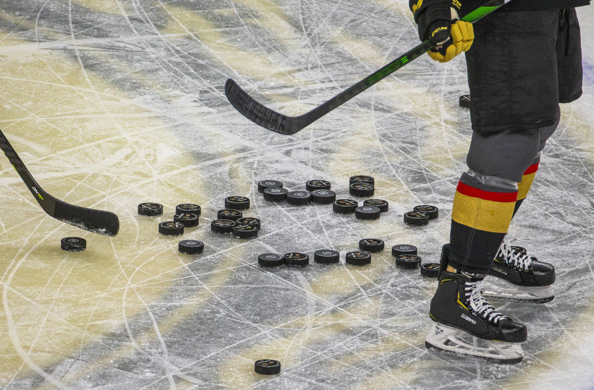 Pucks pile up on the ice as the Vegas Golden Knights warm up before the first period of their N ...