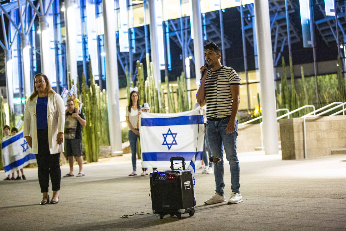 Gal Hayon sings ""Hatikvah," the Israeli national anthem, as the flag of Israel ...