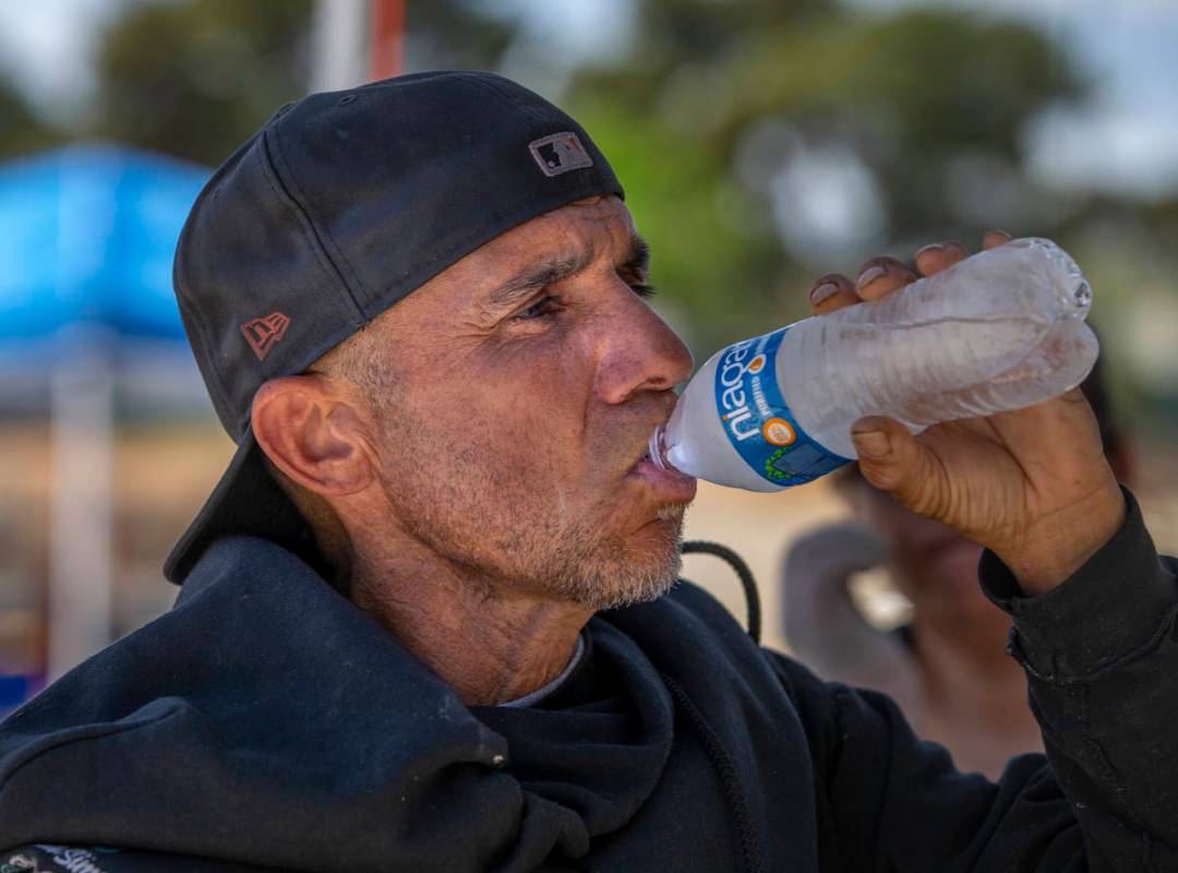 Client Kevin Ball does his best to stay hydrated within the Courtyard Homeless Resource Center ...