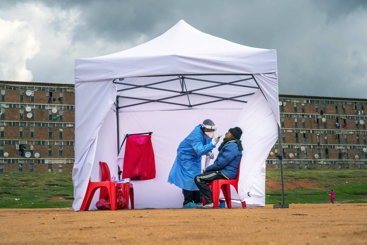 A residents from the Alexandra township gets tested for COVID-19 , in Johannesburg, Wednesday, ...