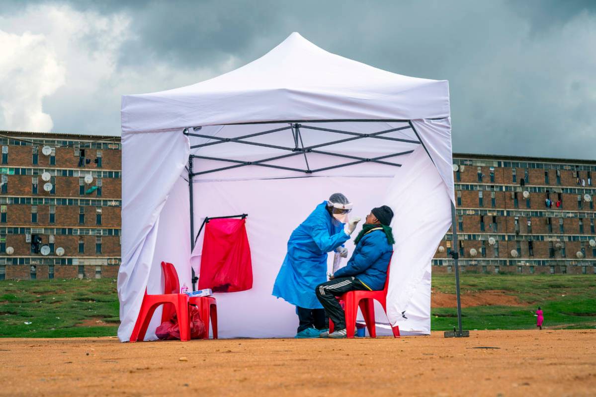 A residents from the Alexandra township gets tested for COVID-19 , in Johannesburg, Wednesday, ...