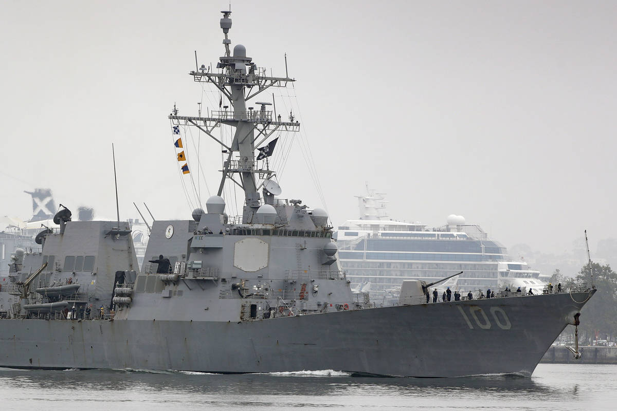 The USS Kidd flies its traditional skull and crossbones flag while passing downtown San Diego a ...