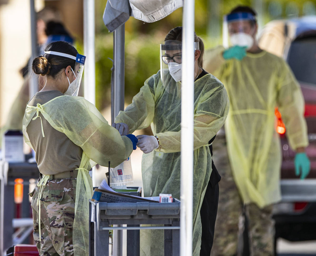 Members of the National Guard assist the UNLV School of Medicine with administering COVID-19 te ...