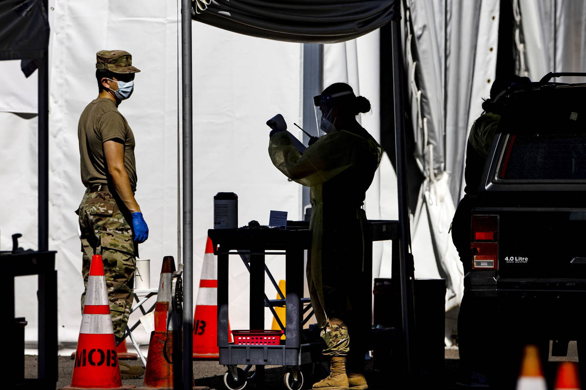 Members of the National Guard assist the UNLV School of Medicine with administering COVID-19 te ...