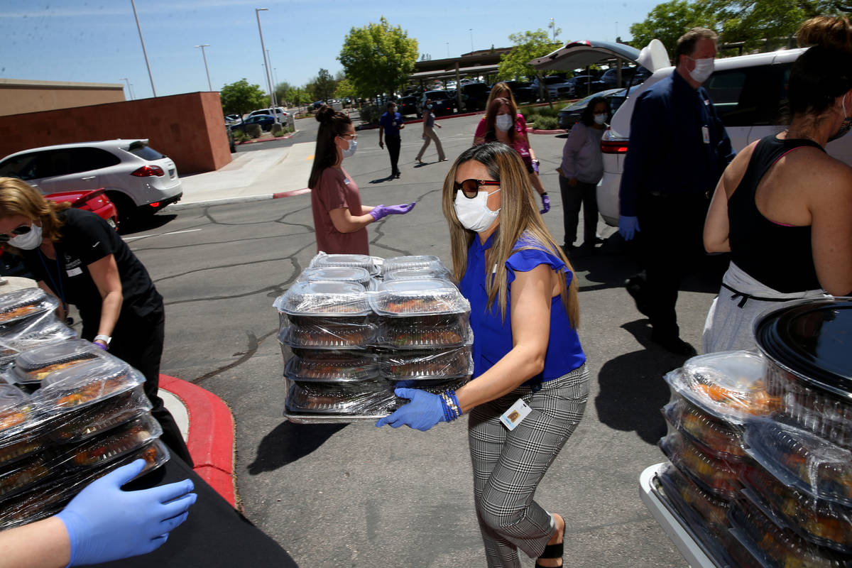 Comprehensive Cancer Centers of Nevada Connie Gutierrez, office manager, loads lunches donated ...