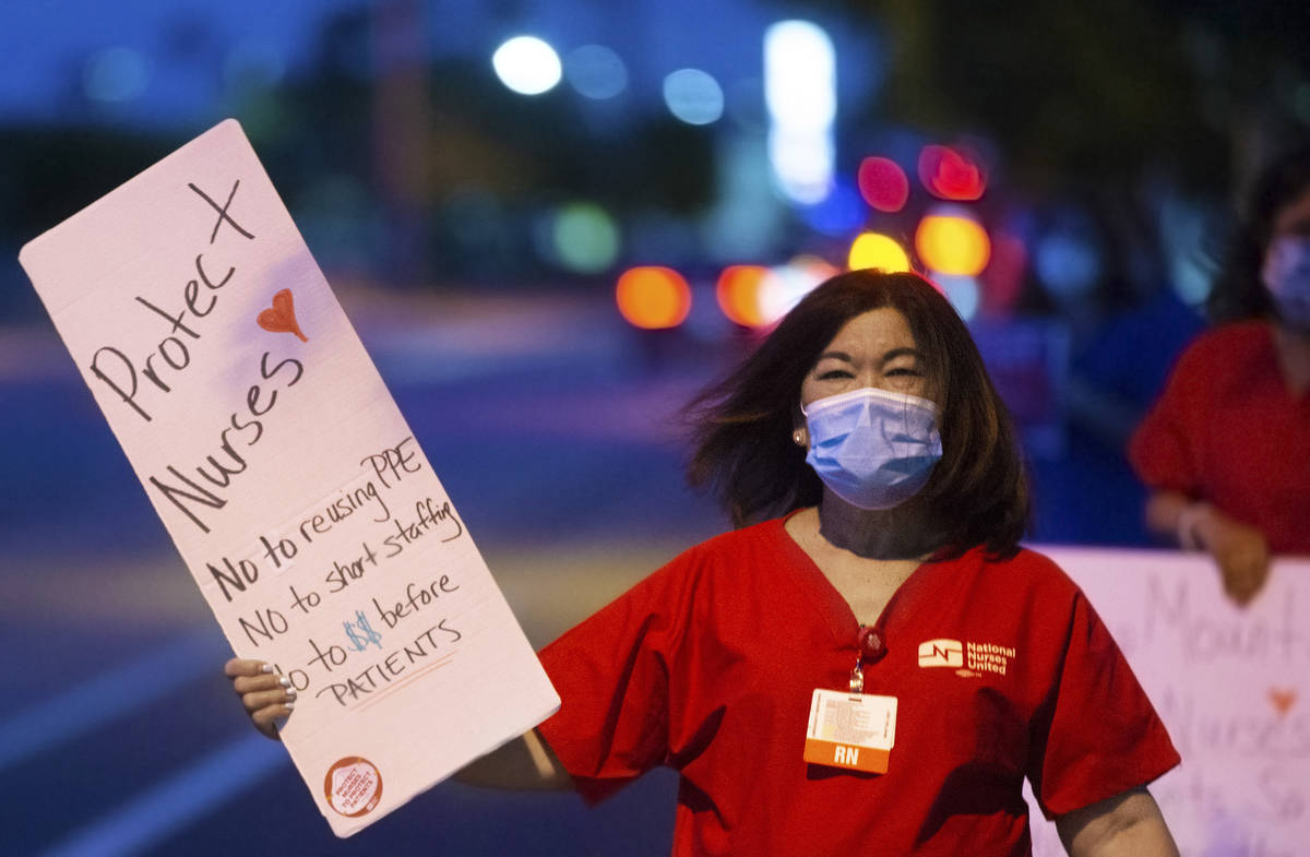 Nurse representative Dina Armstrong holds a sign advocating for better protection, testing and ...