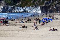 Crowds pack the beach in Pismo Beach, Calif., on the state's central coast on April 25, 2020. ...