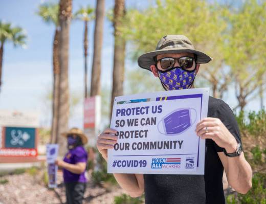 Jason, a Local SEIU 1107 member, holds a sign in protest of unsafe working conditions during th ...