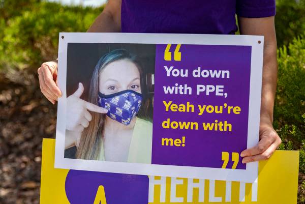 Local SEIU 1107 member holds a sign in protest of unsafe working conditions during the COVID-19 ...