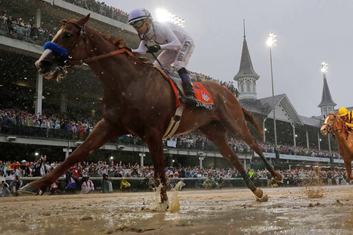 In this May 5, 2018, file photo, Mike Smith rides Justify to victory during the 144th running o ...