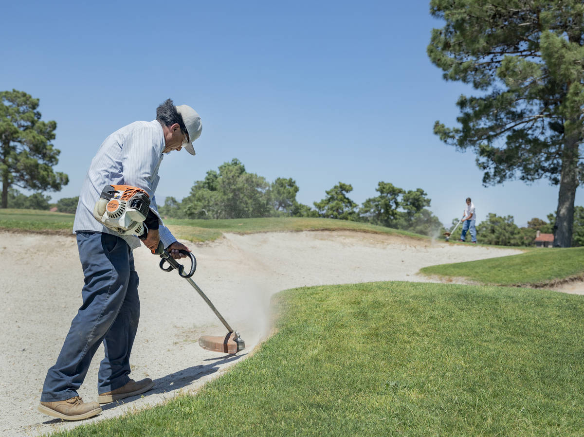 Groundskeepers prepare for the opening of the Spanish Trail Country Club and Golf Course in Las ...