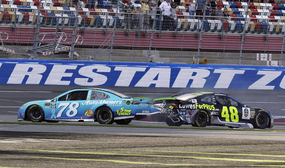 FILE - In this Sept. 30, 2018, file photo, Martin Truex Jr., (78) and Jimmie Johnson (48) crash ...