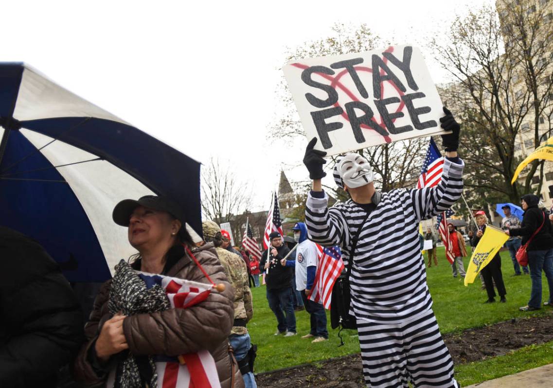 Protesters rally at the state Capitol in Lansing, Mich., Thursday, April 30, 2020. Hoisting Ame ...