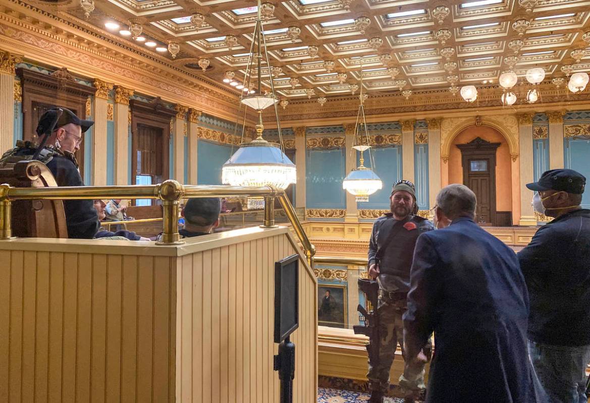 Armed protesters stand in the gallery of the Michigan State Senate chambers at the State Capito ...