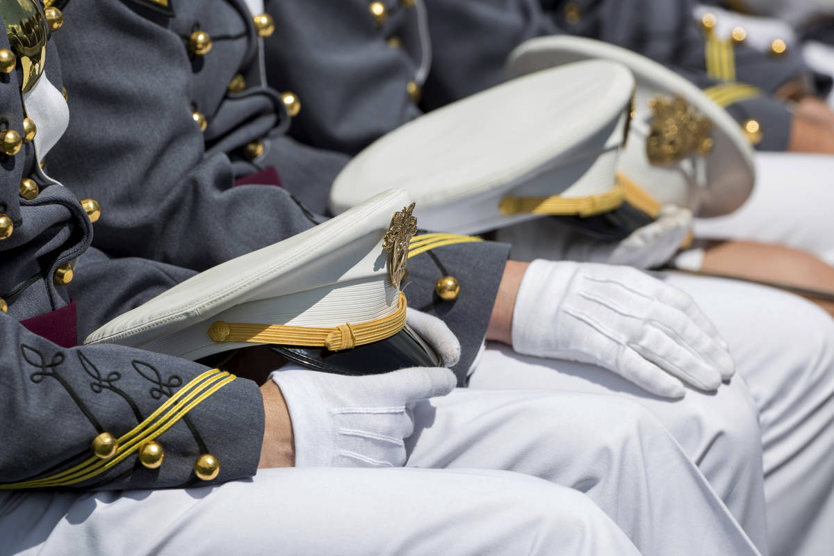 FILE - In this May 25, 2019, file photo West Point cadets hold their caps on their laps during ...
