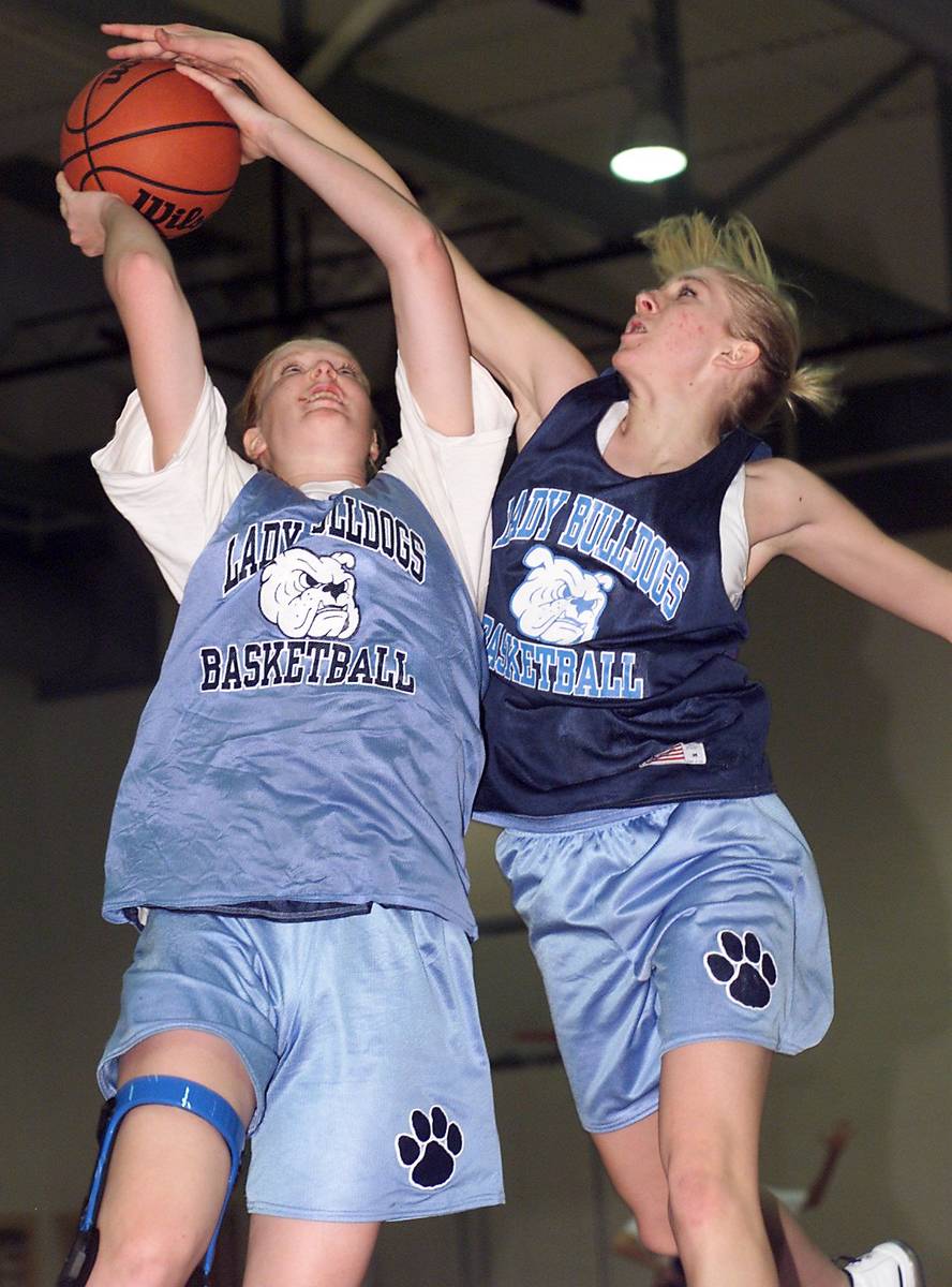 Centennial High School center Heather Thorson, left, goes up for a shot against forward/guard D ...