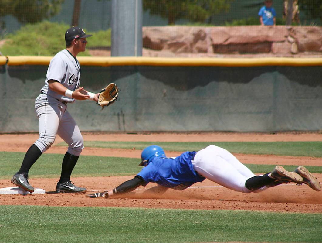 BIshop Gorman Pitcher Jeff Malm slides head first into 3rd base during the state championship g ...