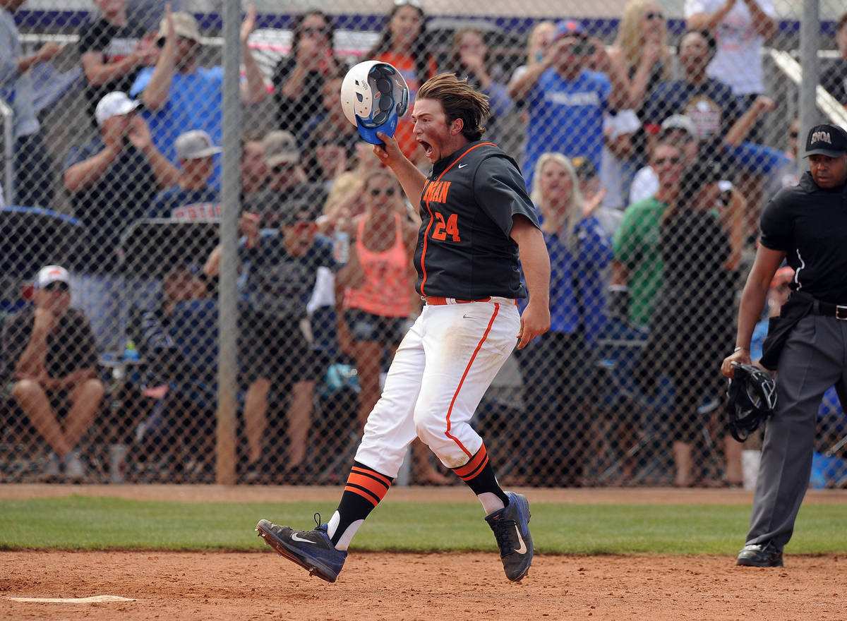 Bishop Gorman first baseman Austin Cram (24) crosses home plate after hitting the tying two-run ...