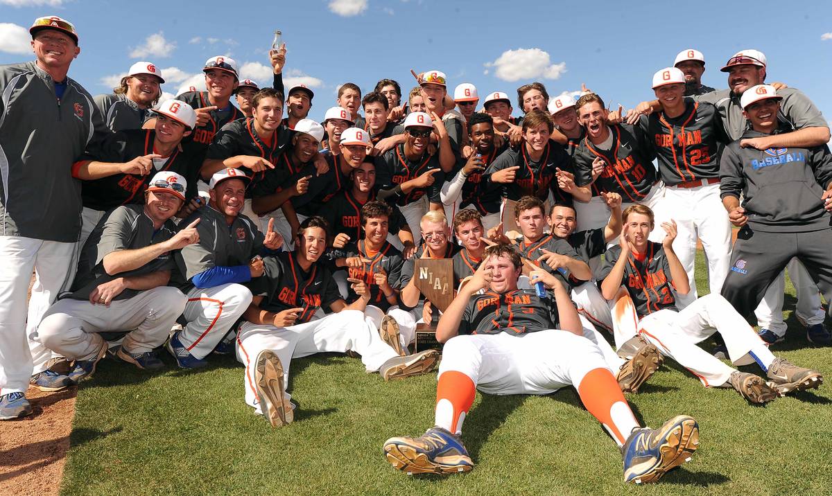 Bishop Gorman players and coaches celebrate with the NIAA trophy after defeating Green Valley 6 ...