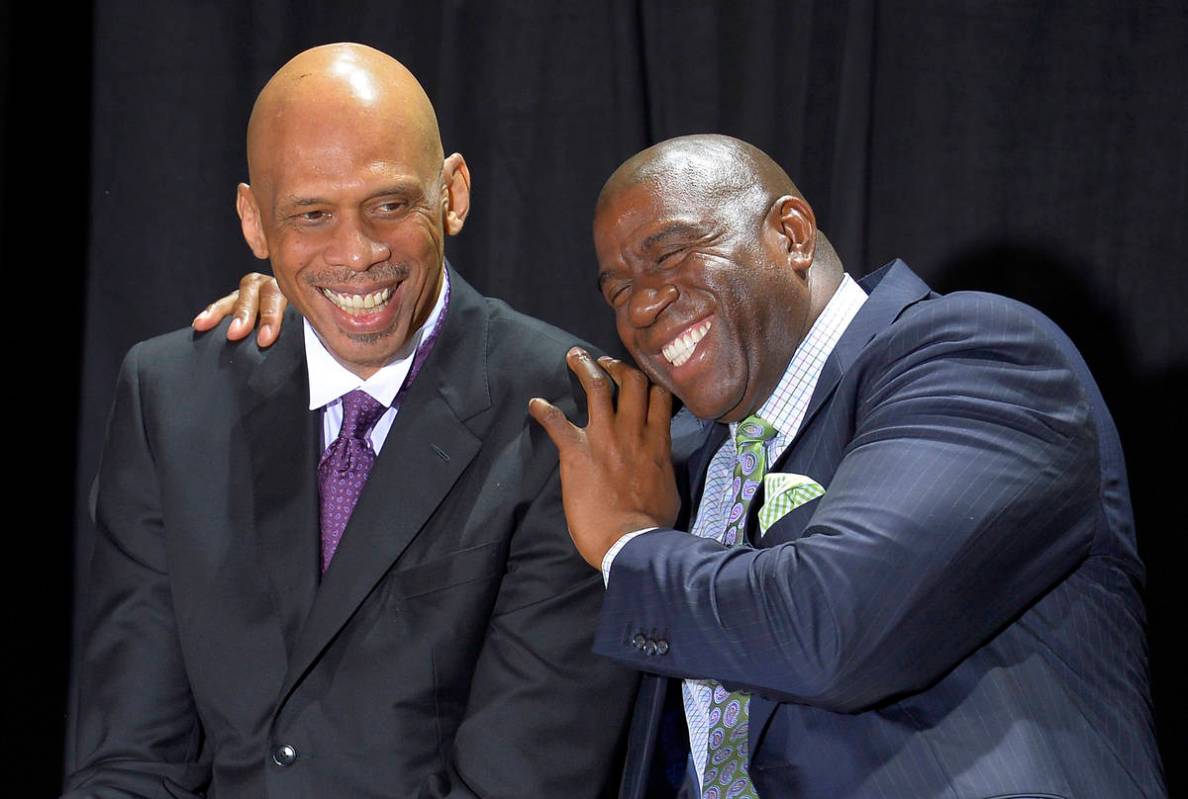 Former Los Angeles Laker Earvin "Magic" Johnson, right, hugs former teammate Kareem A ...