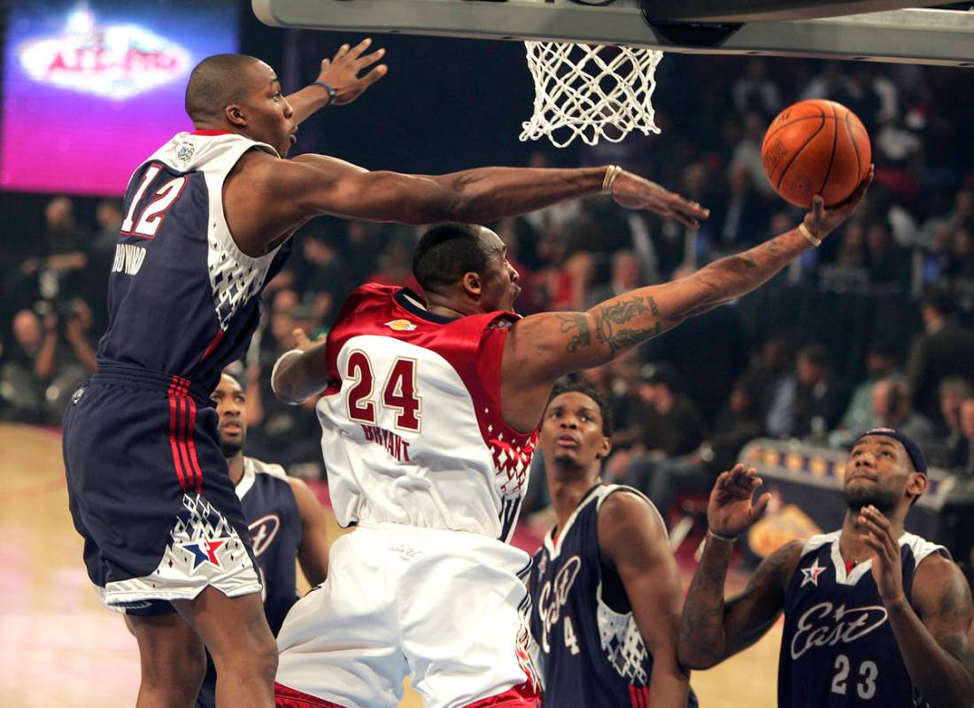 NBA Eastern Conference player (L) Dwight Howard tries to block NBA Western Conference player ( ...