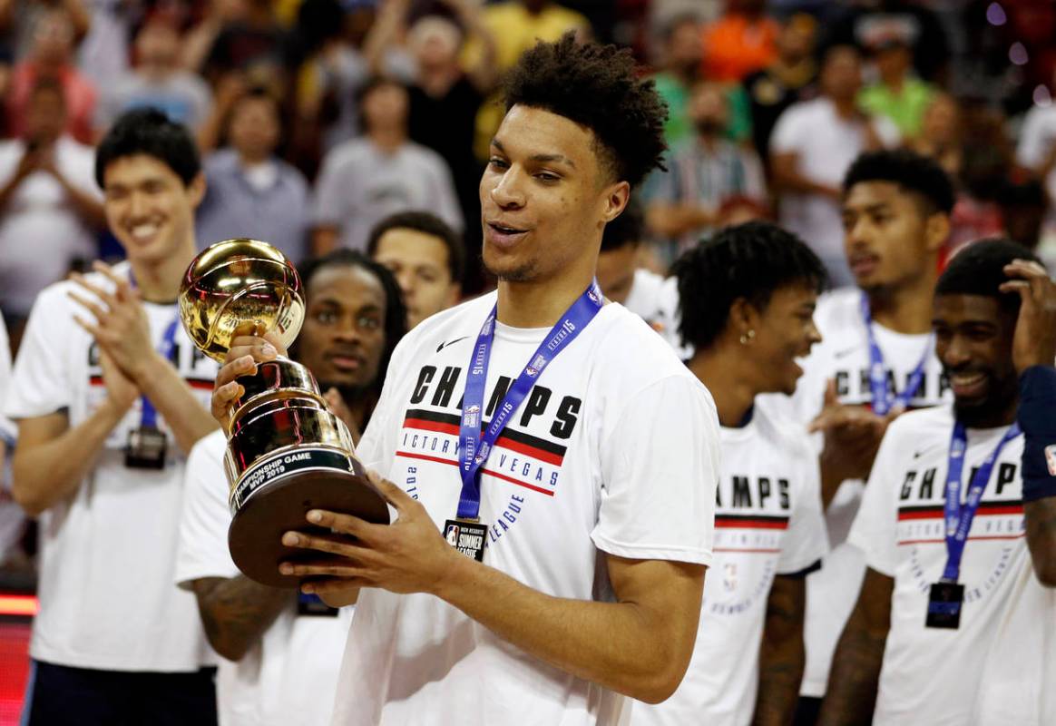 Memphis Grizzlies' Brandon Clarke, foreground, holds the championship game MVP trophy after def ...