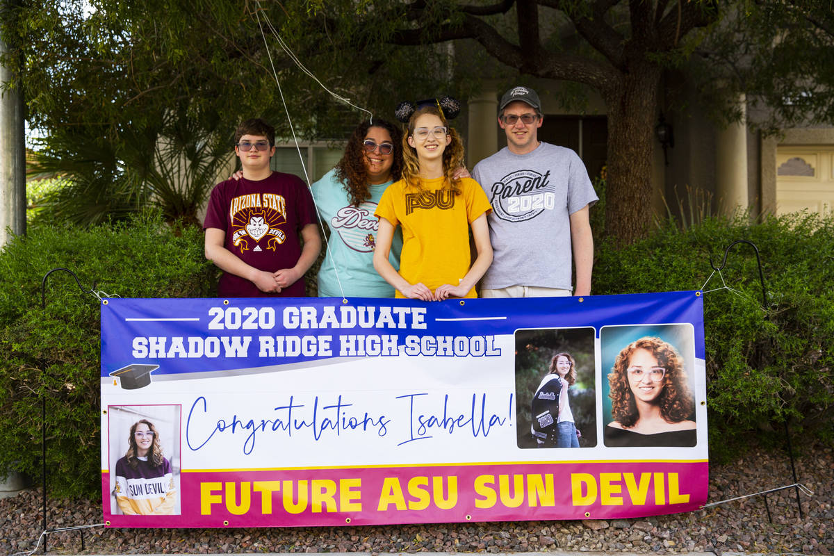 Isabella Rowles, a senior graduating from Shadow Ridge High School, poses for a portrait with h ...