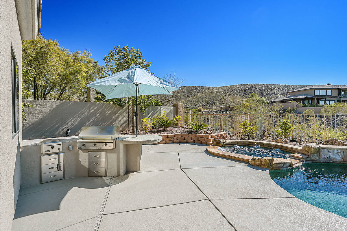 The backyard has an outdoor kitchen. (Huntington & Ellis)