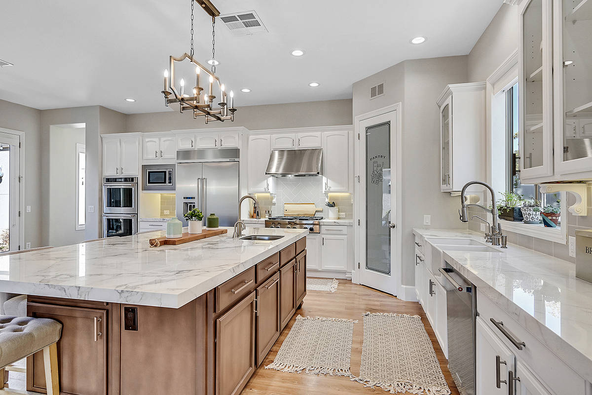 The kitchen has a large center island with seating. (Huntington & Ellis)