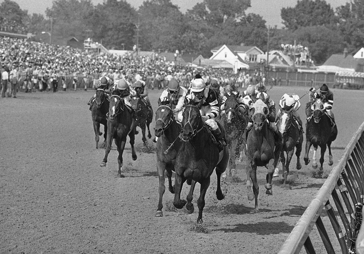 FILE - In this May 7, 1977, file photo, Seattle Slew, with Jean Cruguet up, crosses finish line ...