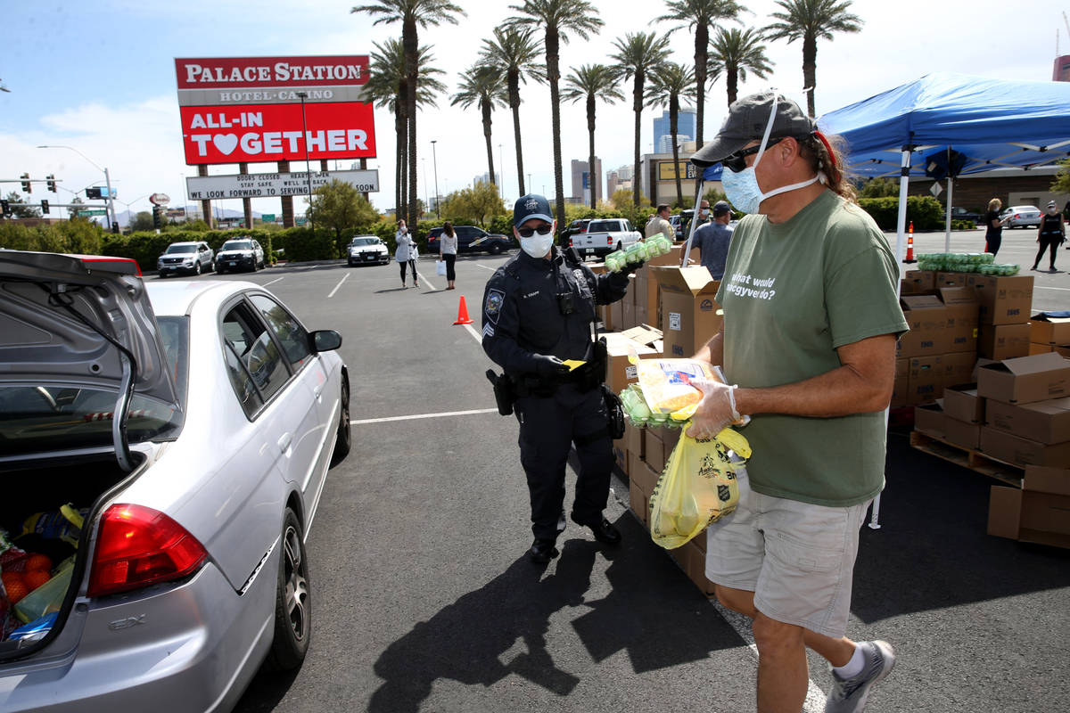 Brian Fisher, 53, of Las Vegas, right, Nevada Highway Patrol Sgt. Brady Knapp and volunteers wi ...