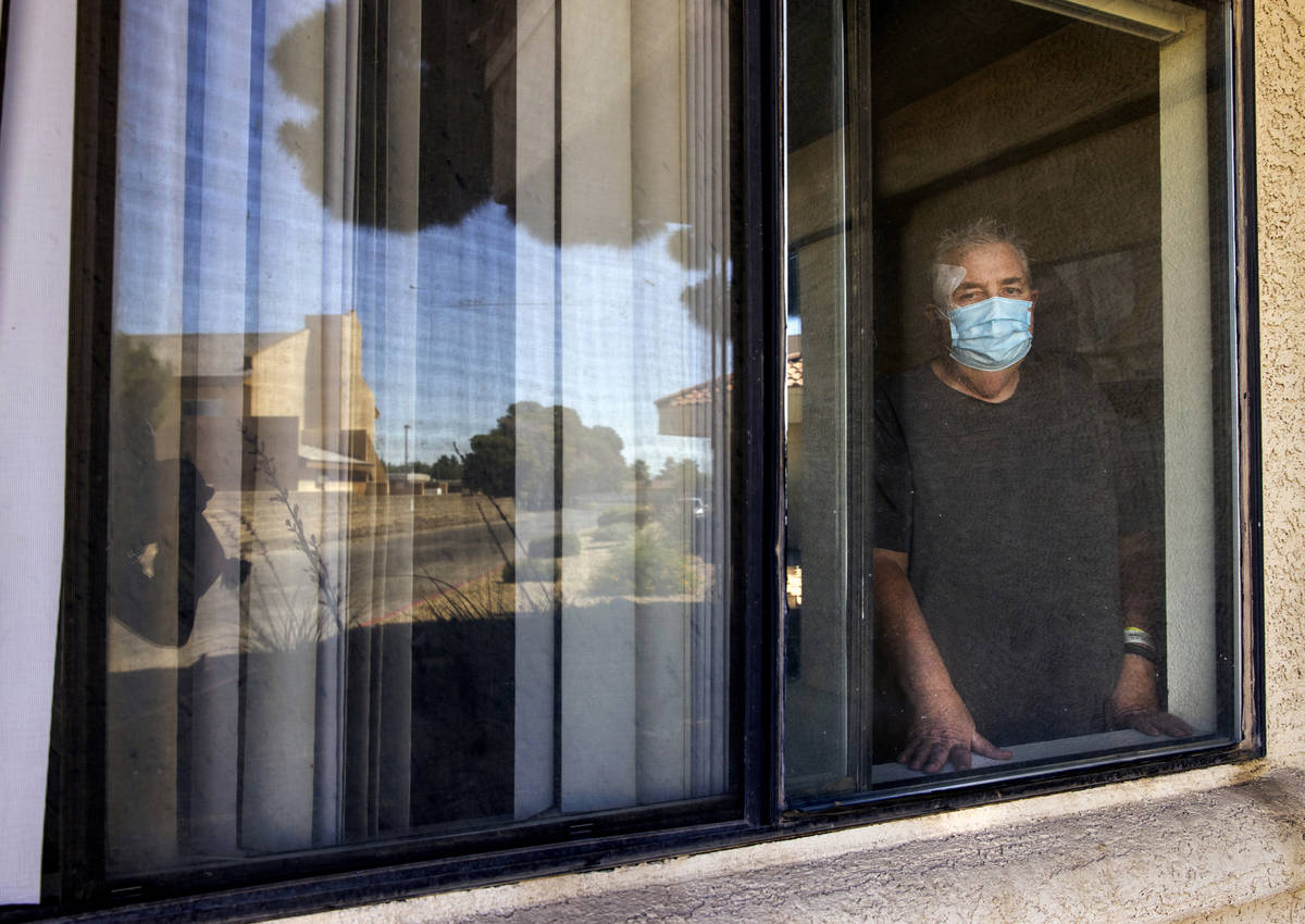 Richard Haacke, from behind the window of his room, is a patient at the College Park Rehabilita ...