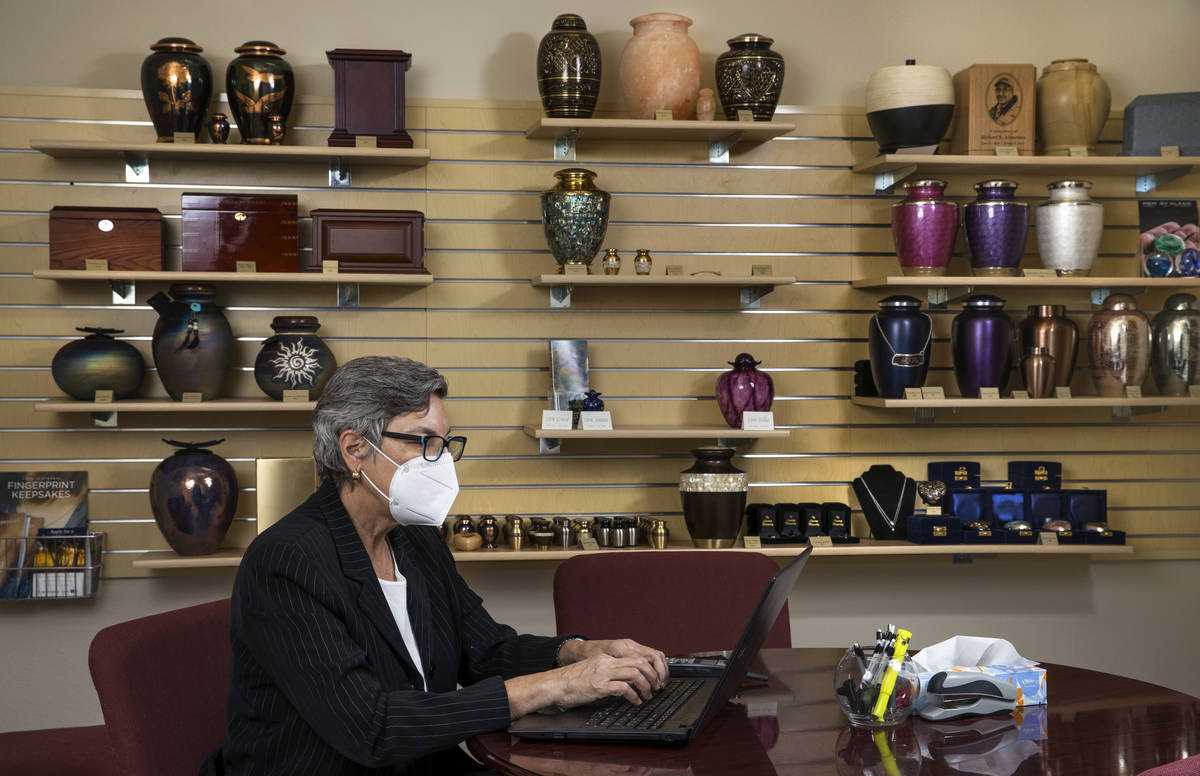 Laura Sussman of Kraft-Sussman Funeral & Cremation Services at a desk within their display ...